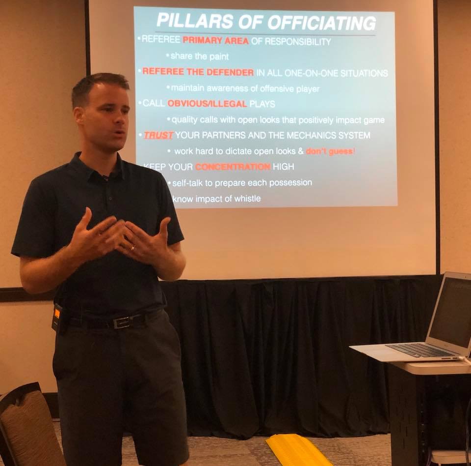 An instructor presenting the Pillars of Officiating during a Let'em Play training clinic