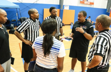 A Let'em Play crew huddling with the assignor before tip-off